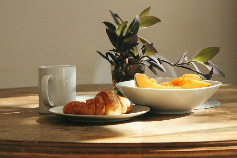 Fresh fruit and croissant on wooden table